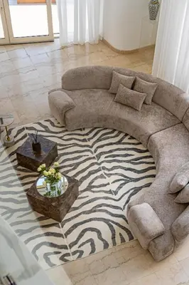 a living room with a large couch on a zebra rug at Private villa in Marina with private pool!!! in Dubai