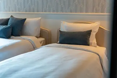 a room with two beds with blue and white pillows at Private villa in Marina with private pool!!! in Dubai