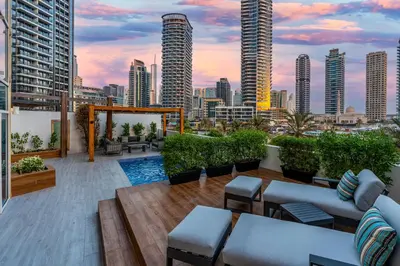 a rooftop patio with a view of a city skyline at Private villa in Marina with private pool!!! in Dubai