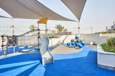 a playground with a slide on a blue carpet at STAY BY LATINEM Luxury 1BR Holiday Home CB 3107 Near Burj Khalifa in Dubai