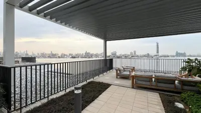 a covered deck with a view of the city at Luxury 2BR 34th Floor Burj Khalifa Sea Creek View in Dubai