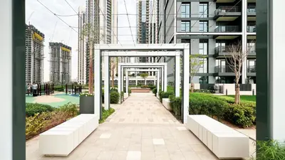 a walkway in a city with tall buildings at Luxury 2BR 34th Floor Burj Khalifa Sea Creek View in Dubai