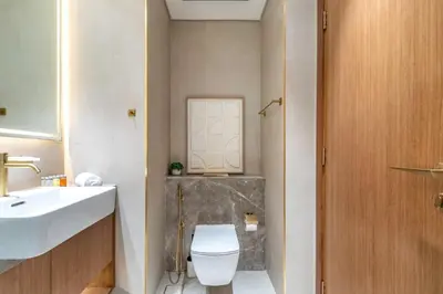 a bathroom with a toilet and a sink at GuestReady - Balcony with Jacuzzi | Canal View in Dubai