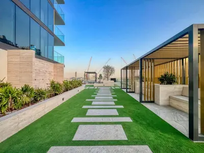 an internal view of a building with a green lawn at GuestReady - Balcony with Jacuzzi | Canal View in Dubai