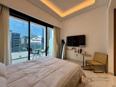 a bedroom with a large bed and a large window at Stylish Studio In Azizi Riviera 59 in Dubai