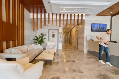 a man is standing in a living room at Work & Relax Above the City- JVC Perfect Stay in Dubai