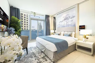 a bedroom with a bed and a large window at Stunning Studio facing Burj Khalifa in Dubai