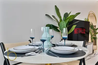 a table with plates and wine glasses on it at Bookable Stylish Dubai escape with private pool in Dubai