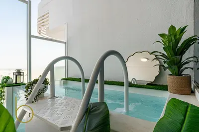 a room with a pool with a chair and a table at Bookable Stylish Dubai escape with private pool in Dubai