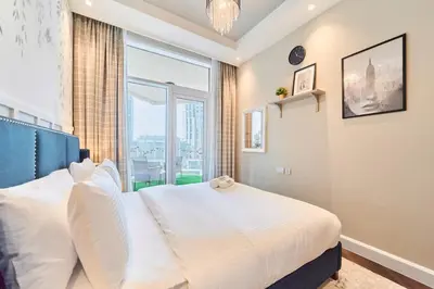 a bedroom with a bed with a large window at FAM Living Contemporary 1BR Apartment Urban Oasis in Dubai