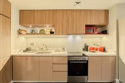 a kitchen with a sink and a stove at FAM Living Contemporary 1BR Apartment Urban Oasis in Dubai