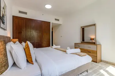 a bedroom with a large bed and a mirror at Residences 1 Tower 5 E2 - 2BR Apartment - Allsopp & Allsopp in Dubai