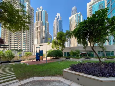 a park in the middle of a city with tall buildings at Residences 1 Tower 5 E2 - 2BR Apartment - Allsopp & Allsopp in Dubai