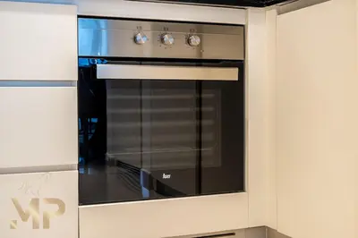 a kitchen with a black oven in a wall at Marcopolo - Experience modern living in Business Bay Dubai in Dubai