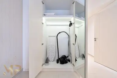 a room with a closet with a sink and a mirror at Marcopolo - Experience modern living in Business Bay Dubai in Dubai