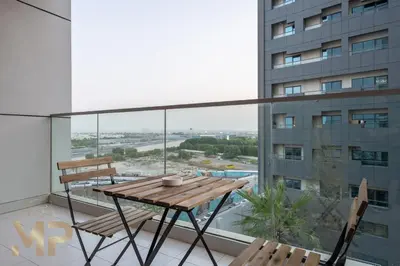 a balcony with a wooden table and two chairs at Marcopolo - Experience modern living in Business Bay Dubai in Dubai