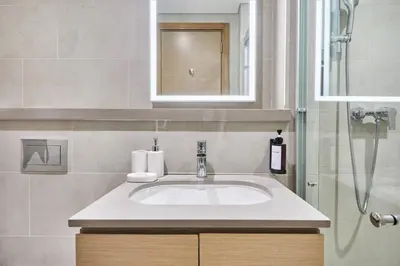 a bathroom sink with a mirror and a shower at STAY BY LATINEM Luxury 1BR Holiday Home W 2809 Near Burj Khalifa in Dubai