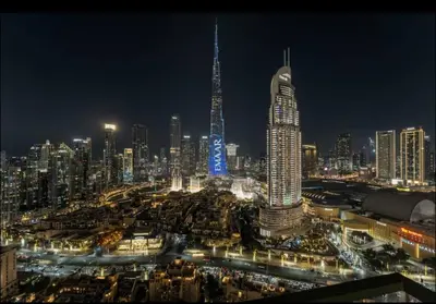 a city skyline at night with a tall building at Full Burj Khalifa View, 3min Walk to Dubai Mall, 29th floor in Dubai