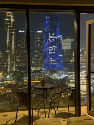 a view of a city at night from a window at Full Burj Khalifa View, 3min Walk to Dubai Mall, 29th floor in Dubai