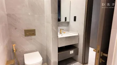 a bathroom with a white sink and a toilet at FIVE Palm Jumeirah 3BR plus Luxury Lifestyle Residence in Dubai