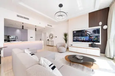 a living room with a couch and a large tv at High-Floor Upgraded 3-Bed Marina Apartment in Dubai