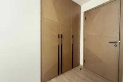 a closet with a wooden door in a room at Luxury 1 Bed Apt in Palace, Dubai Creek Harbour in Dubai