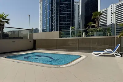 a swimming pool on the roof of a building at Stylish and Spacious Downtown Studio in Dubai