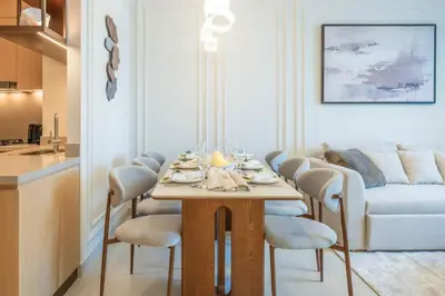 a dining room with a table with chairs and a couch at New 2BR Luxe Vida Dubai Mall Direct Access in Dubai