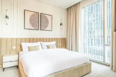 a bedroom with a large white bed and large windows at New 2BR Luxe Vida Dubai Mall Direct Access in Dubai