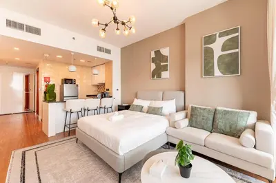 a living room with a bed and a couch at HAVN - Studio in Al Jawhara, JVT in Dubai
