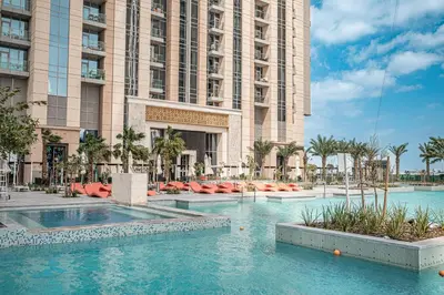 a hotel with a swimming pool in front of a building at Luxury Leisure Massive Pool Oasis in Amna Tower in Dubai