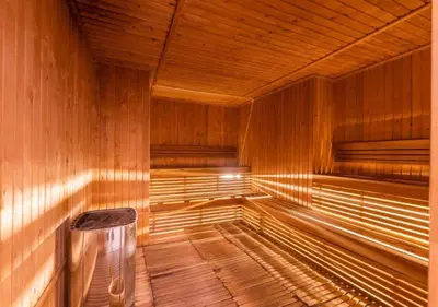 an empty wooden sauna with a bench in it at City Forest Studio in JVC in Dubai