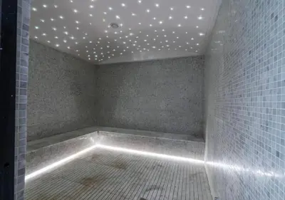 a bathroom with a tub with lights on the ceiling at City Forest Studio in JVC in Dubai