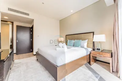 a bedroom with a large bed and a television at Panoramic Dubai Water Canal Views 1BR with Seamless Access to Marina Mall, Steps from the Tram, The Address Residences, Dubai Marina by Deluxe Holiday Homes in Dubai
