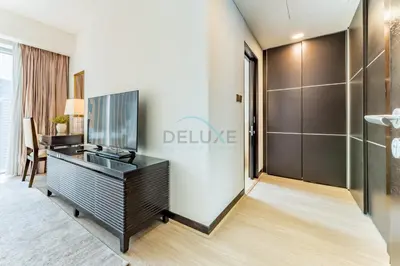 a room with a desk with a tv on it at Panoramic Dubai Water Canal Views 1BR with Seamless Access to Marina Mall, Steps from the Tram, The Address Residences, Dubai Marina by Deluxe Holiday Homes in Dubai