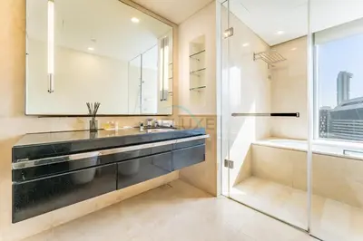 a bathroom with a sink and a shower at Panoramic Dubai Water Canal Views 1BR with Seamless Access to Marina Mall, Steps from the Tram, The Address Residences, Dubai Marina by Deluxe Holiday Homes in Dubai