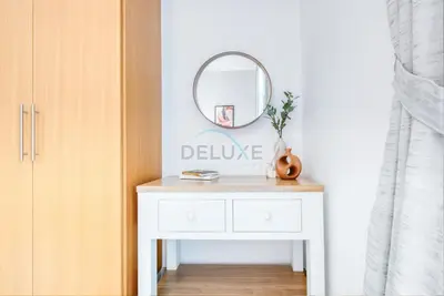 a white dressing table with a mirror in a room at Fresh 2BR at Mudon Views 4, Dubailand by Deluxe Holiday Homes in Dubai