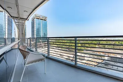a chair on the balcony of a building at Located Near Museum of the Future and Index Mall, Just a few Minutes Drive from Burj Khalifa and Dubai Mall - Sky Gardens, DIFC by Deluxe Holiday Homes in Dubai