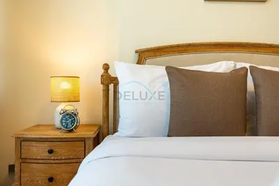 a bedroom with a bed and an alarm clock on a night stand at Located Near Museum of the Future and Index Mall, Just a few Minutes Drive from Burj Khalifa and Dubai Mall - Sky Gardens, DIFC by Deluxe Holiday Homes in Dubai