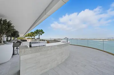 an outdoor patio with a view of the water at Newly Styled 1BD in Grand Bleu Beachfront, Fits 4 in Dubai