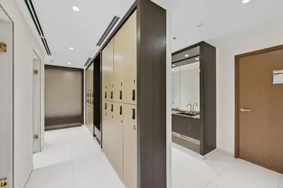 a hallway with a bathroom with a sink and a closet at Newly Styled 1BD in Grand Bleu Beachfront, Fits 4 in Dubai