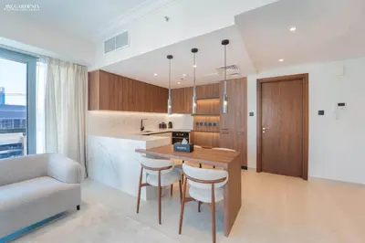 a kitchen with a table and chairs in a room at Downtown Dubai- Modern upgraded 1 BR Plus Study Room with Luxury Interiors and Partial Fountain Views in Dubai