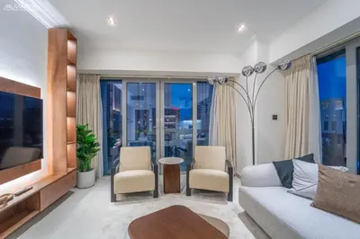 a living room with a couch and a table at Downtown Dubai- Modern upgraded 1 BR Plus Study Room with Luxury Interiors and Partial Fountain Views in Dubai