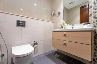 a bathroom with a toilet and a sink at GuestReady - Golf View | Park Access | DAMAC Hills in Dubai