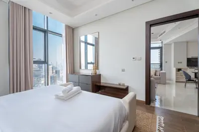 a bedroom with a white bed and a large window at GuestReady - City 1BR | Heart of Business Bay in Dubai