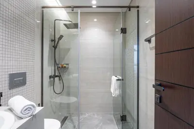 a shower with a glass door in a bathroom at GuestReady - City 1BR | Heart of Business Bay in Dubai