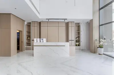 a lobby with a reception desk in a building at Urban Oasis - Modern Studio Retreat with City Views in Dubai