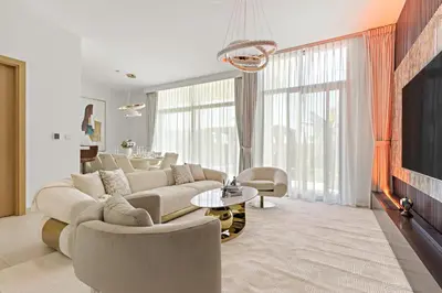 a living room with a large couch and chairs at Luxury 4BR and Maid Room Townhouse Tilal Al Furjan in Dubai