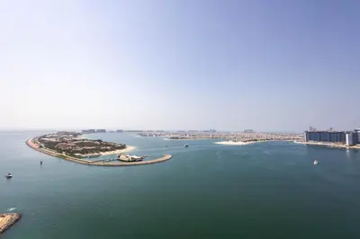 an island in the middle of a large body of water at Dubai Dream Stay - 2-BR with Sea View in Beach Vista in Dubai