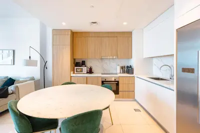 a kitchen and dining room with a table and chairs at Dubai Dream Stay - 2-BR with Sea View in Beach Vista in Dubai